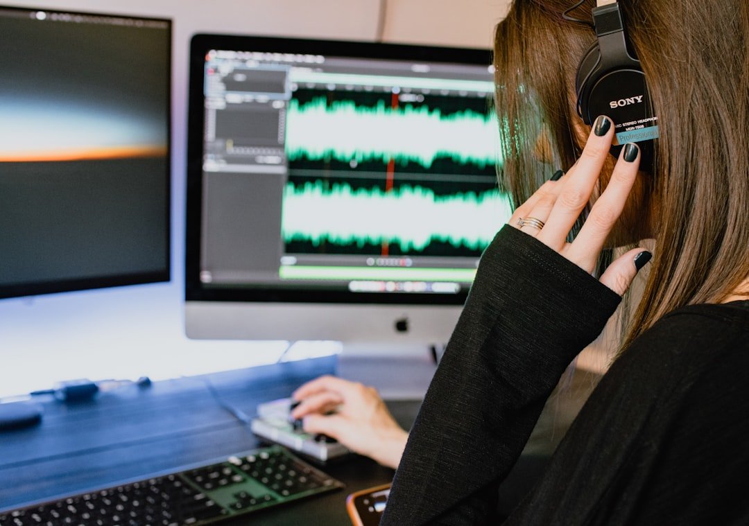 woman in black long sleeve shirt using black laptop computer martinic audio